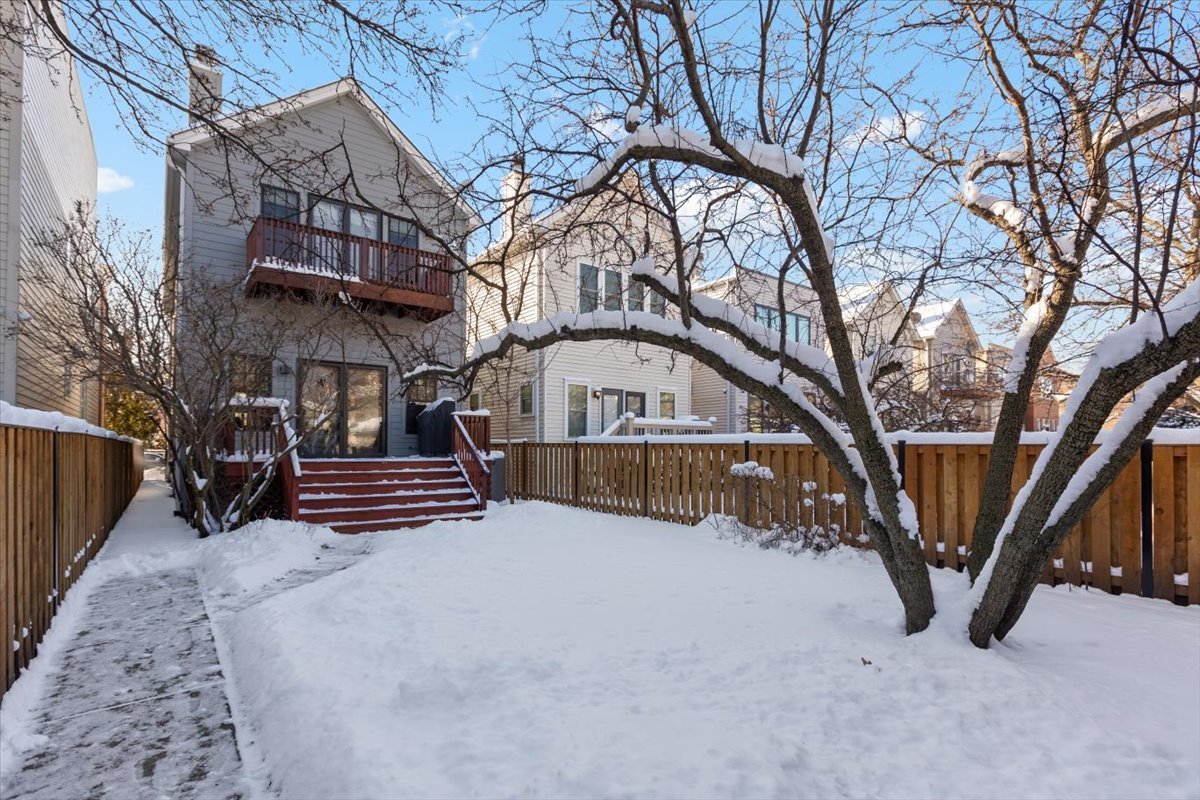 332 West Goethe Street Chicago, IL 60610 - Photo 25 of 29 a view of a house with a yard and wooden fence