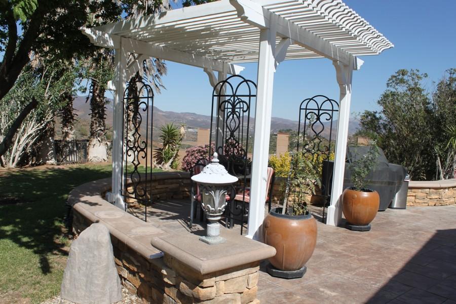 6110 Hubbard Road Acton, CA 93510 - Photo 24 of 46 a view of a patio with table and chairs potted plants and a palm tree