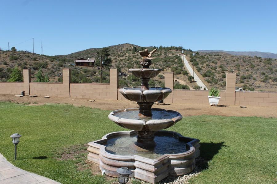 6110 Hubbard Road Acton, CA 93510 - Photo 26 of 46 a view of a fountain in a yard with plants and a fountain