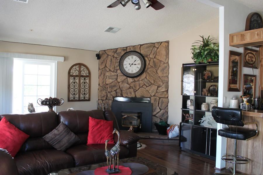 6110 Hubbard Road Acton, CA 93510 - Photo 29 of 46 a living room with furniture a fireplace and a potted plant