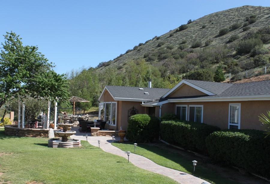 6110 Hubbard Road Acton, CA 93510 - Photo 4 of 46 a view of a house with backyard sitting area and garden
