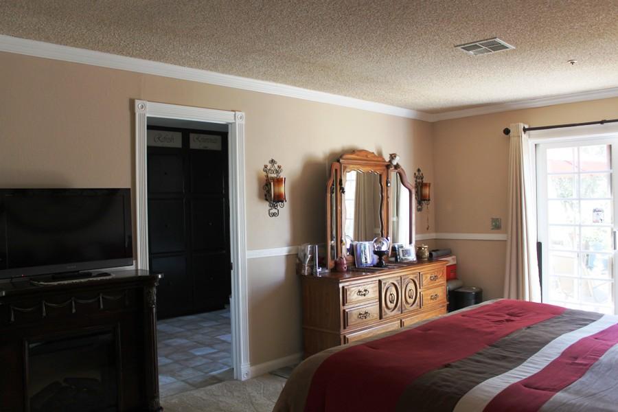 6110 Hubbard Road Acton, CA 93510 - Photo 41 of 46 a bedroom with a bed and a flat tv screen on a dresser