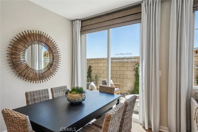 a view of a dining room with furniture and window
