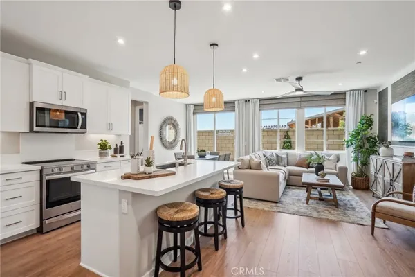 a large kitchen with a table and chairs