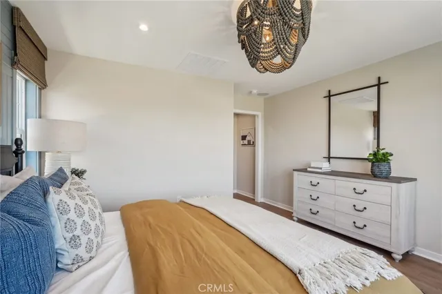 a bedroom with a bed and a mirror