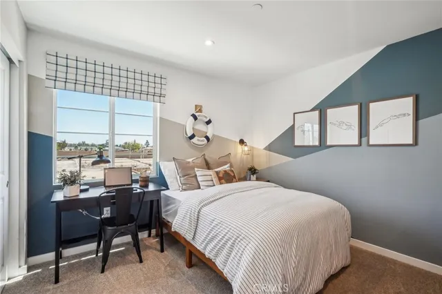 a bedroom with a bed and a large window