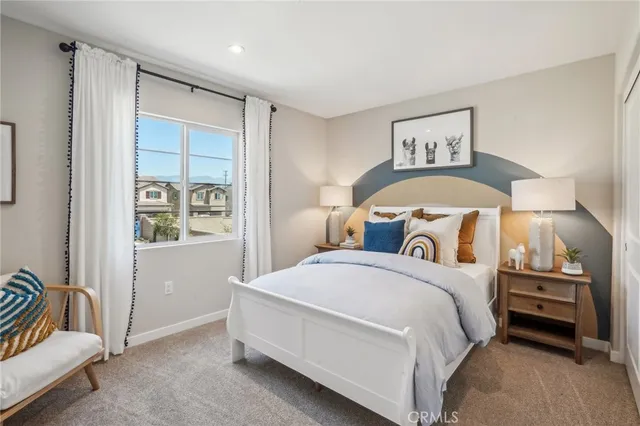 a bedroom with a bed and a painting on the wall