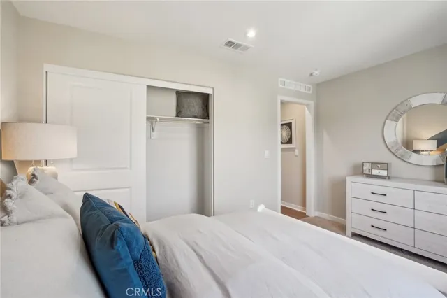 a bedroom with a bed and a dresser