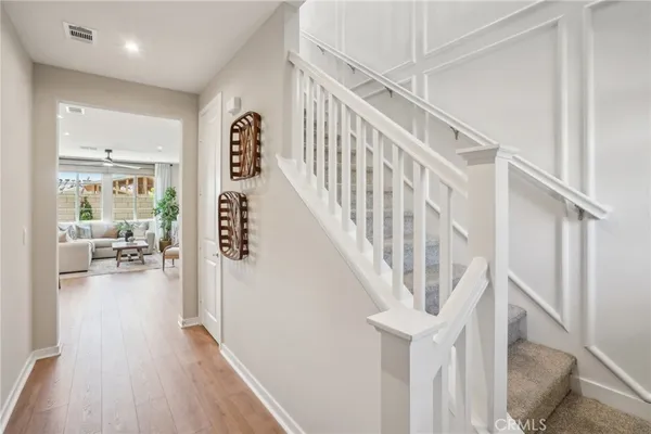 a view of entryway and hall with wooden floor