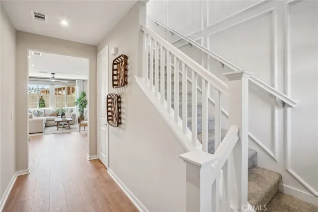 a view of entryway and hall with wooden floor