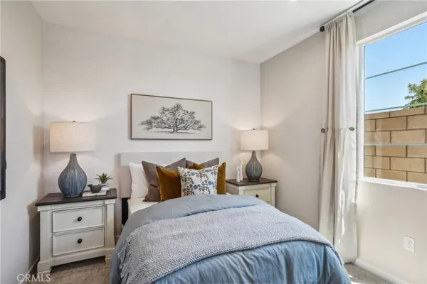 a bedroom with a bed and dressers