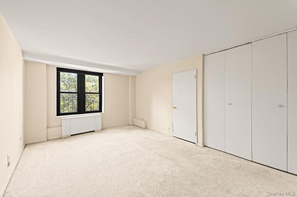 18-75 Corporal Kennedy Street, Unit 3J Queens, NY 11360 - Photo 12 of 27 a view of an empty room with a window