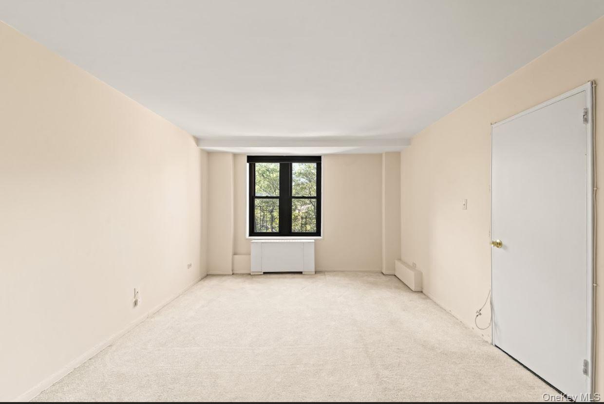 18-75 Corporal Kennedy Street, Unit 3J Queens, NY 11360 - Photo 13 of 27 an empty room with windows