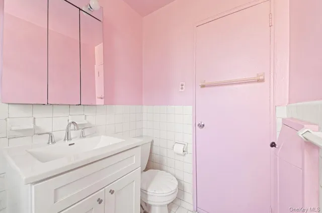 a bathroom with a sink a toilet and vanity