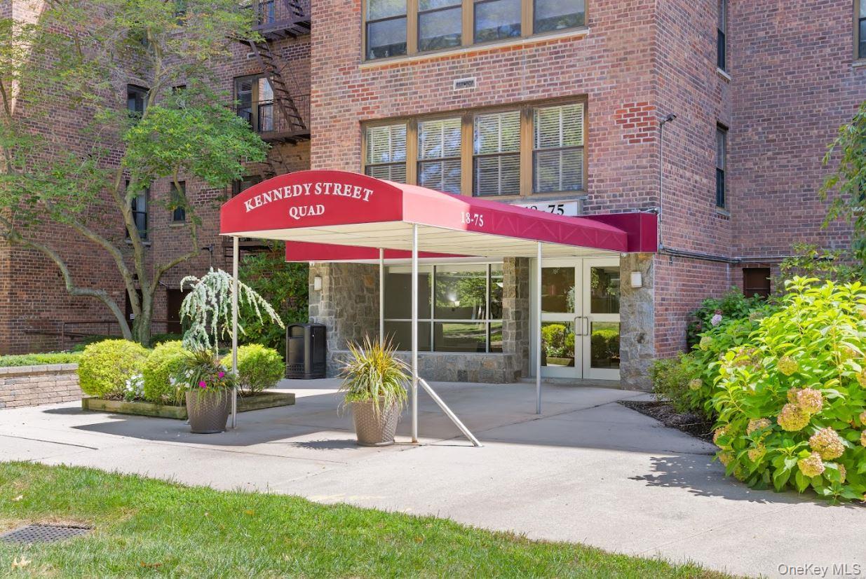 18-75 Corporal Kennedy Street, Unit 3J Queens, NY 11360 - Photo 19 of 27 a view of a house with backyard sitting area and garden
