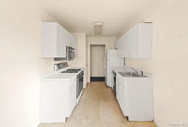 a kitchen with sink a stove and refrigerator