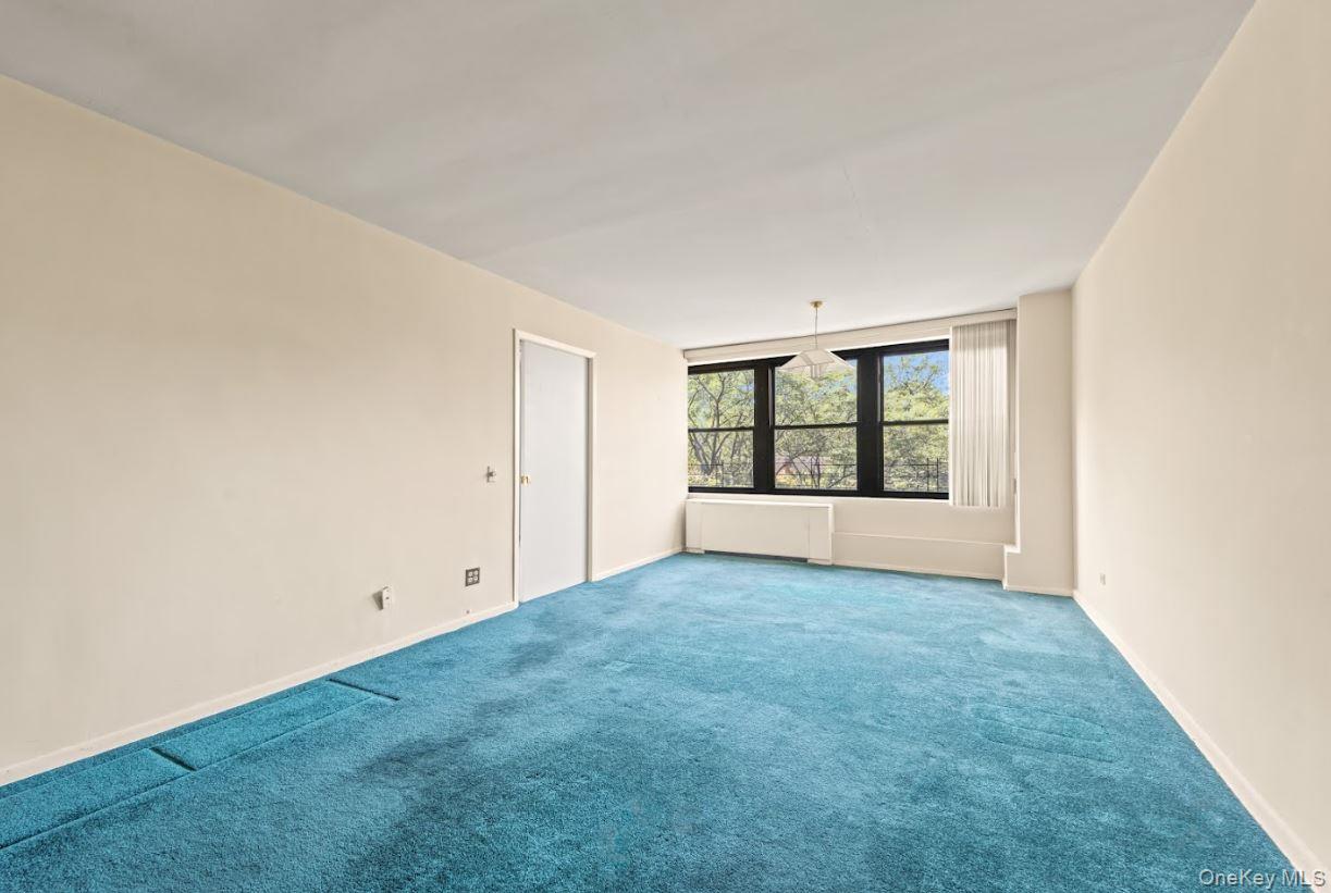 18-75 Corporal Kennedy Street, Unit 3J Queens, NY 11360 - Photo 9 of 27 an empty room with windows