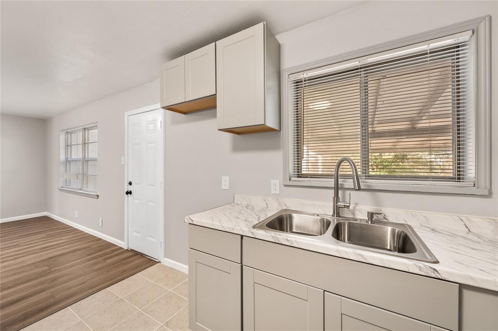 415 Walnut Street Duncanville, TX 75116 - Photo 11 of 22 a kitchen with stainless steel appliances granite countertop a sink and a window