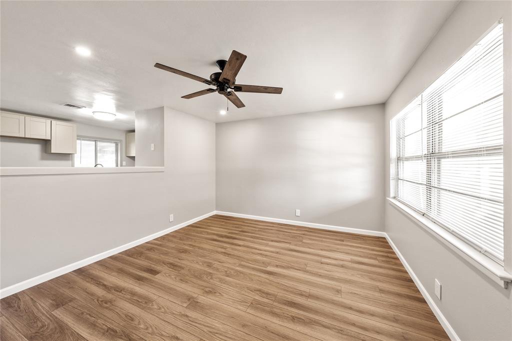 415 Walnut Street Duncanville, TX 75116 - Photo 3 of 22 wooden floor in an empty room with a window