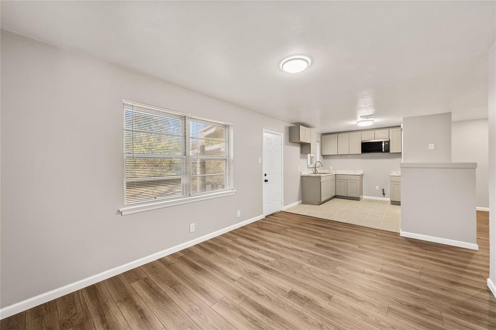 415 Walnut Street Duncanville, TX 75116 - Photo 7 of 22 a view of empty room with wooden floor and window
