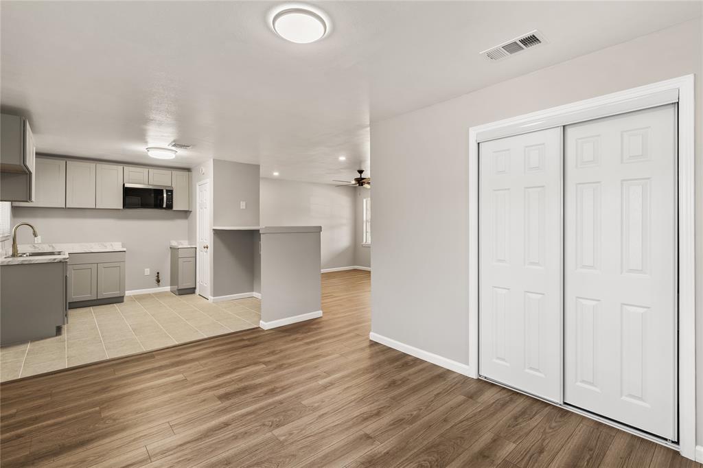 415 Walnut Street Duncanville, TX 75116 - Photo 8 of 22 a view of a kitchen with wooden floor and a sink