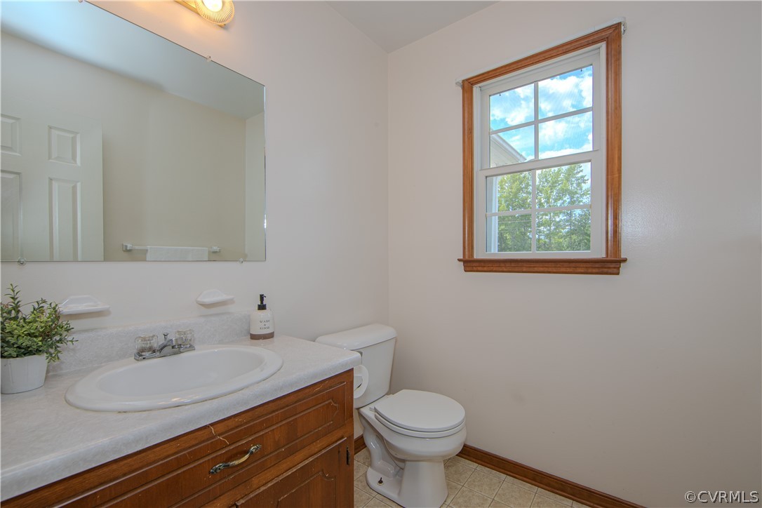 15895 Loving Union Road Disputanta, VA 23842 - Photo 13 of 42 a bathroom with a sink toilet and a mirror