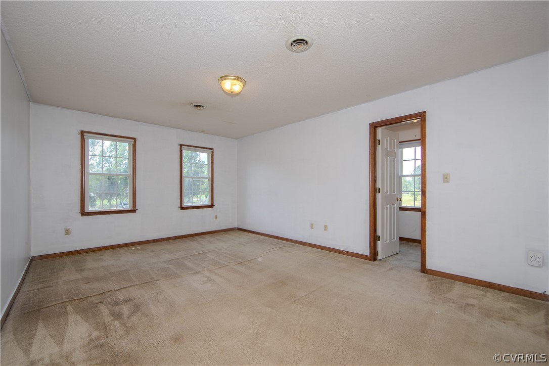 15895 Loving Union Road Disputanta, VA 23842 - Photo 20 of 42 an empty room with windows and closet