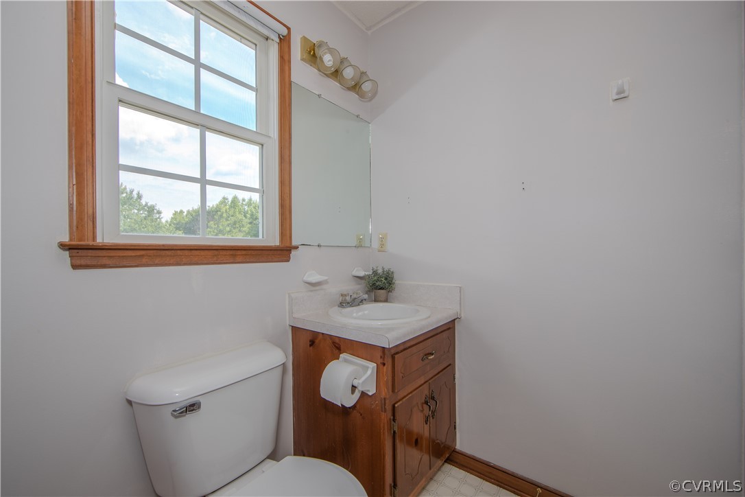 15895 Loving Union Road Disputanta, VA 23842 - Photo 29 of 42 a bathroom with a toilet sink and mirror