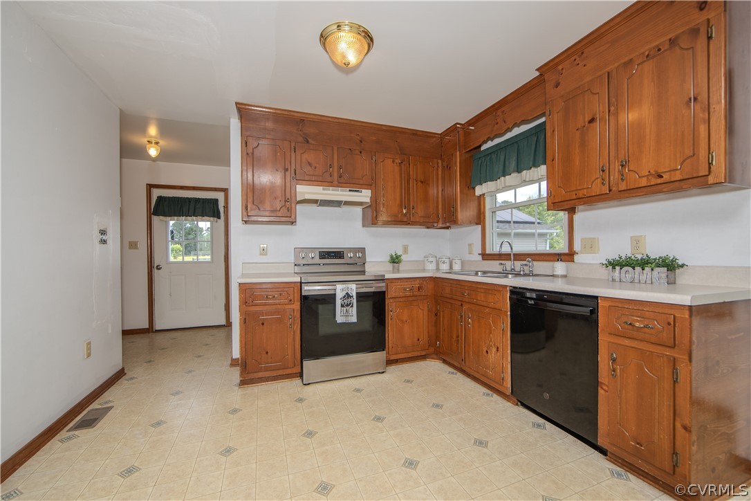 15895 Loving Union Road Disputanta, VA 23842 - Photo 7 of 42 a kitchen with stainless steel appliances granite countertop a stove top oven a sink dishwasher and a refrigerator with wooden cabinets