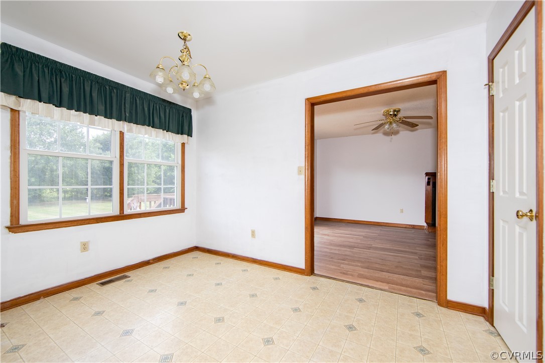15895 Loving Union Road Disputanta, VA 23842 - Photo 8 of 42 an empty room with a chandelier