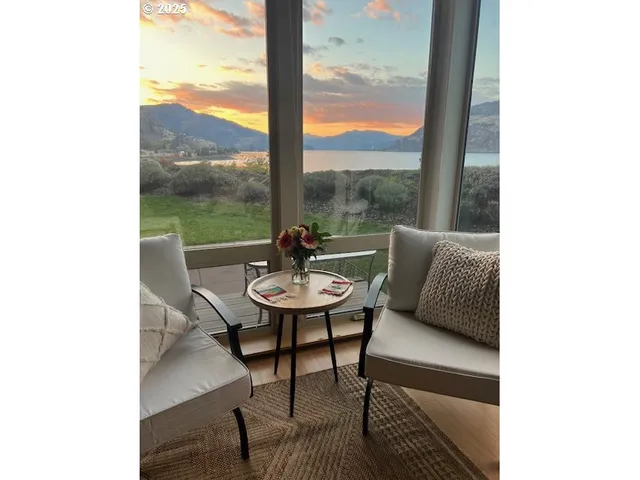 a living room with furniture and large windows