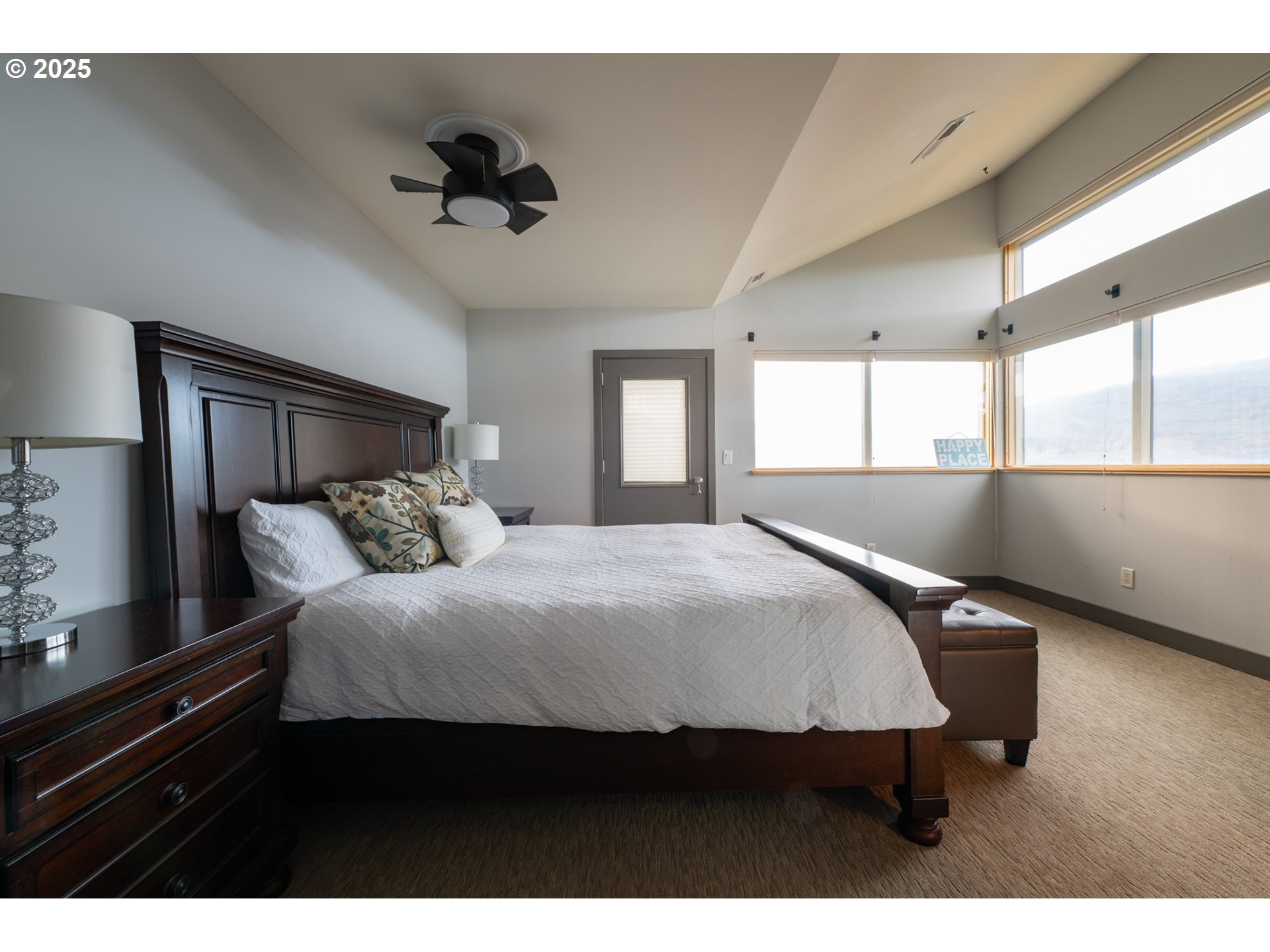 26 Mosier Creek Place, Unit 26 Mosier, OR 97040 - Photo 18 of 38 a bedroom with a bed and a large window