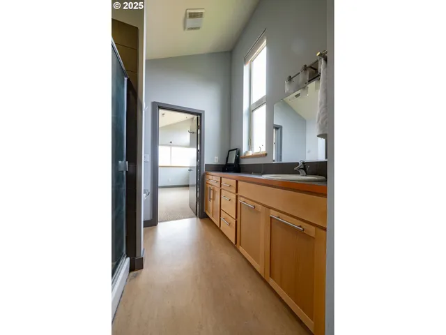 a bedroom with a bed and a large mirror