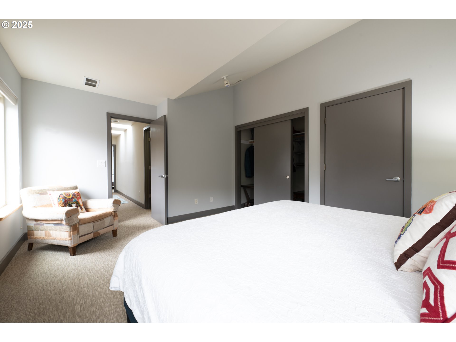 26 Mosier Creek Place, Unit 26 Mosier, OR 97040 - Photo 24 of 38 a bedroom with a bed and a large mirror