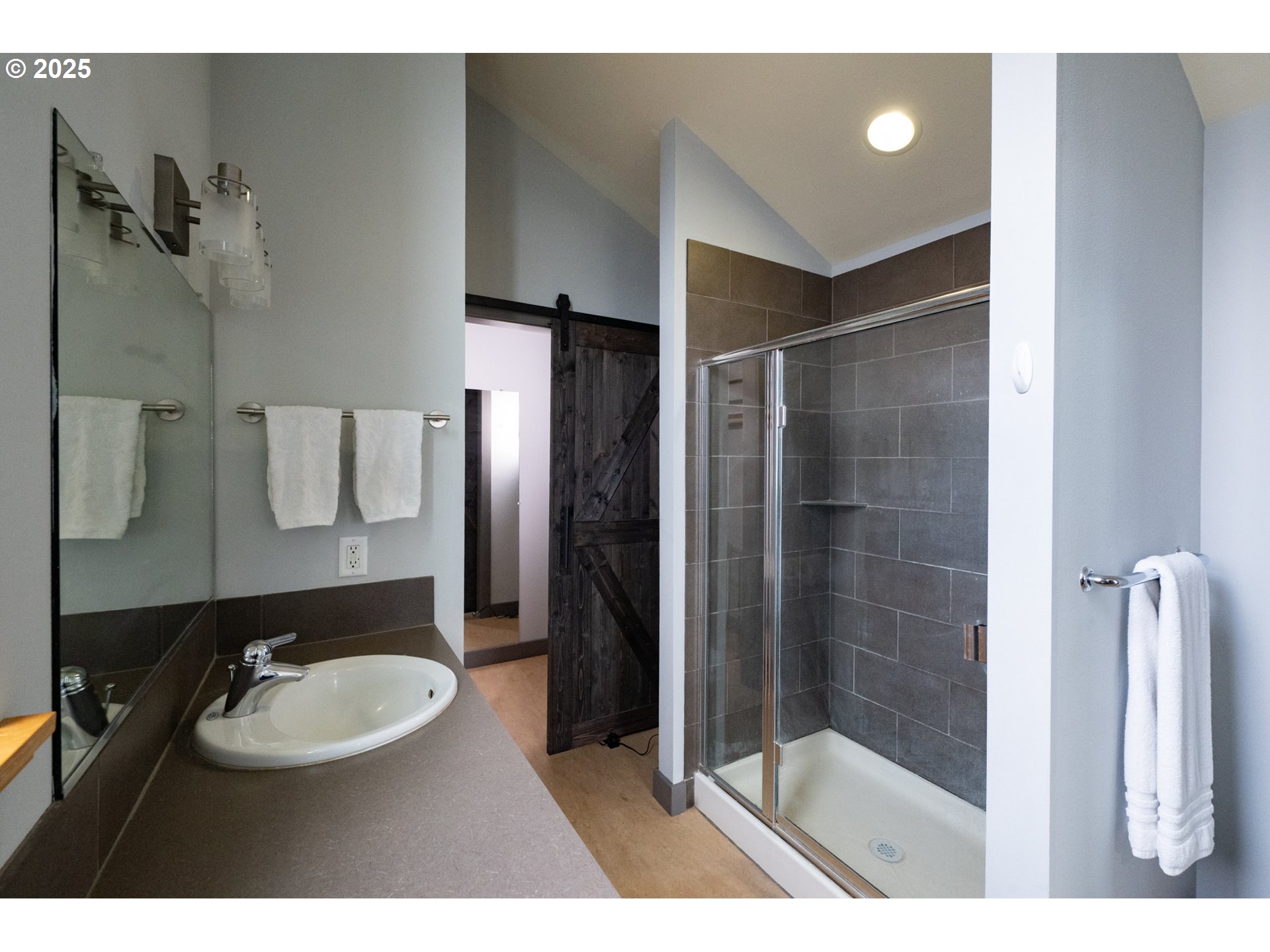 26 Mosier Creek Place, Unit 26 Mosier, OR 97040 - Photo 26 of 38 a bathroom with a sink shower and a mirror