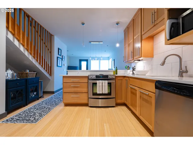 a kitchen with a sink a stove top oven and refrigerator