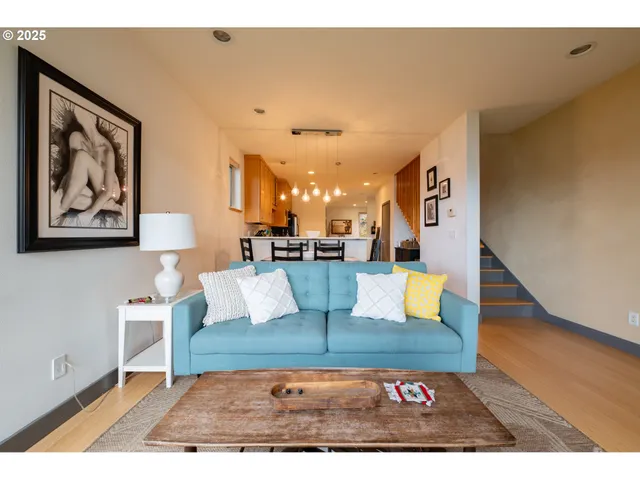 a view of living room with furniture and wooden floor