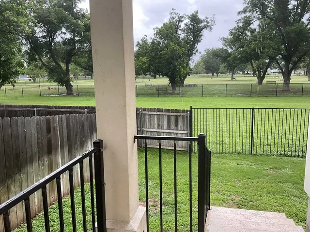 a view of backyard with deck and a garden
