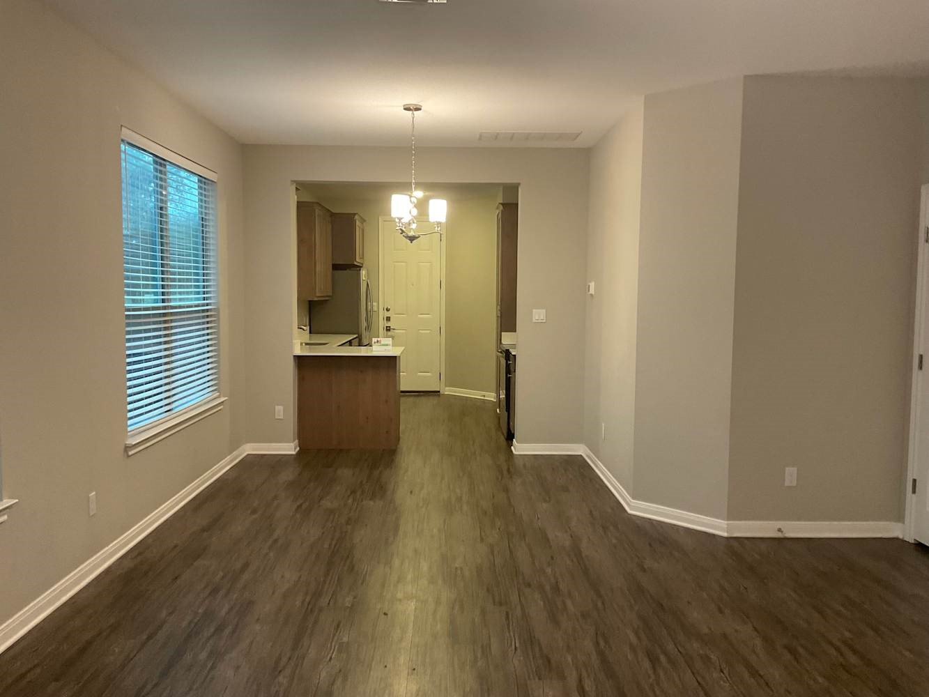 179 Holly Street Georgetown, TX 78626 - Photo 4 of 13 an empty room with wooden floor and windows