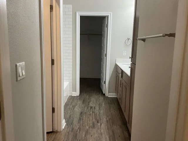 a view of a hallway with wooden floor and a hallway