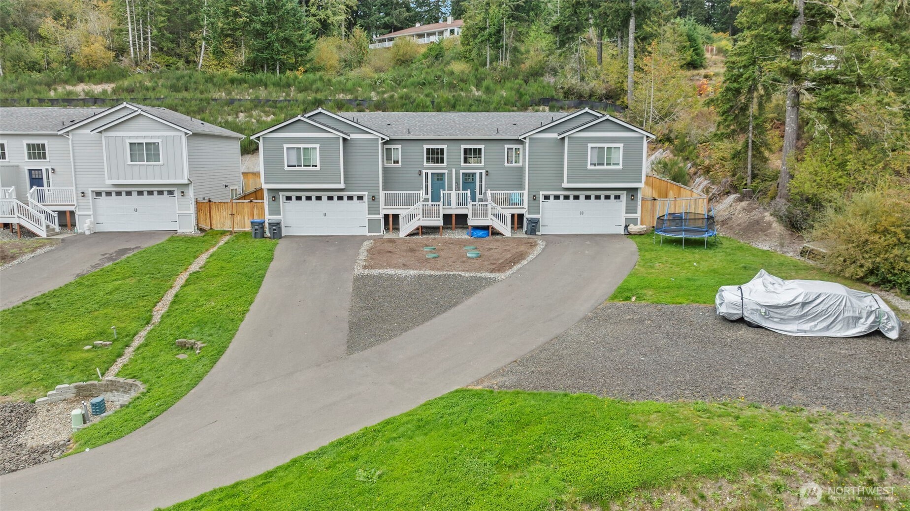 19019 Highway 3, Unit AB Allyn, WA 98524 - Photo 2 of 32 a front view of a house with a garden and yard
