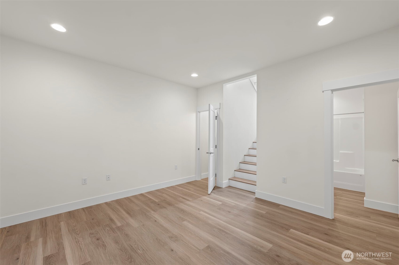 19019 Highway 3, Unit AB Allyn, WA 98524 - Photo 22 of 32 a view of a hallway with stairs and wooden floor