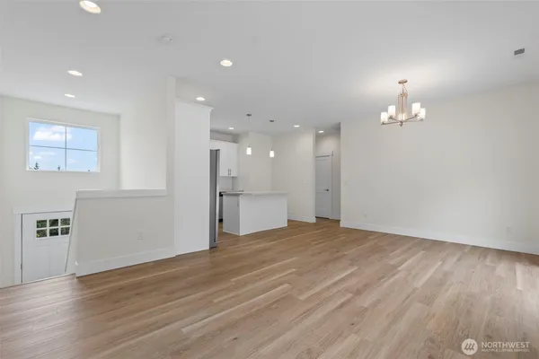 a view of a livingroom with a ceiling fan window and wooden floor