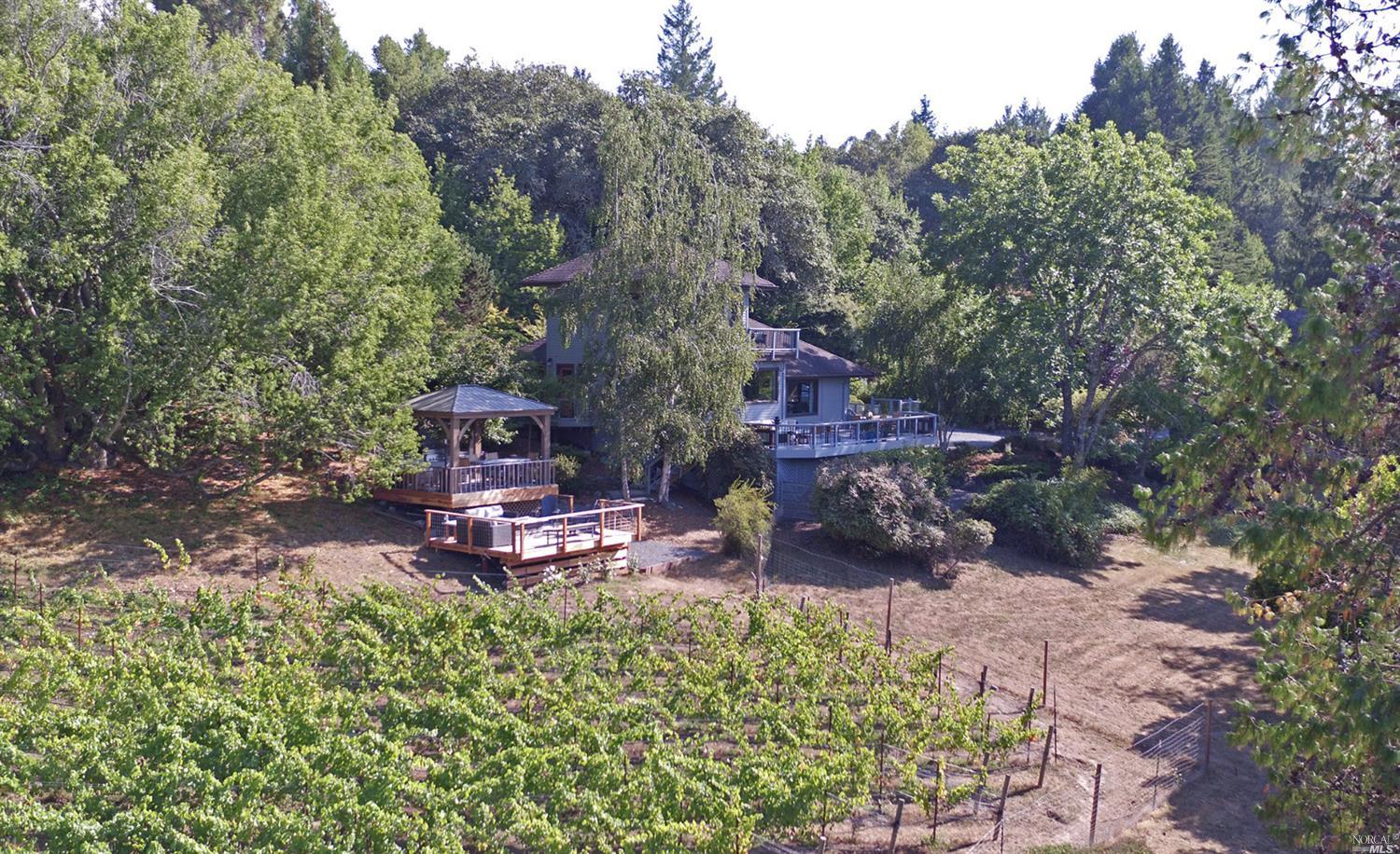 a view of a house with a yard and sitting area