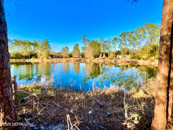 a view of a lake with a house in the background