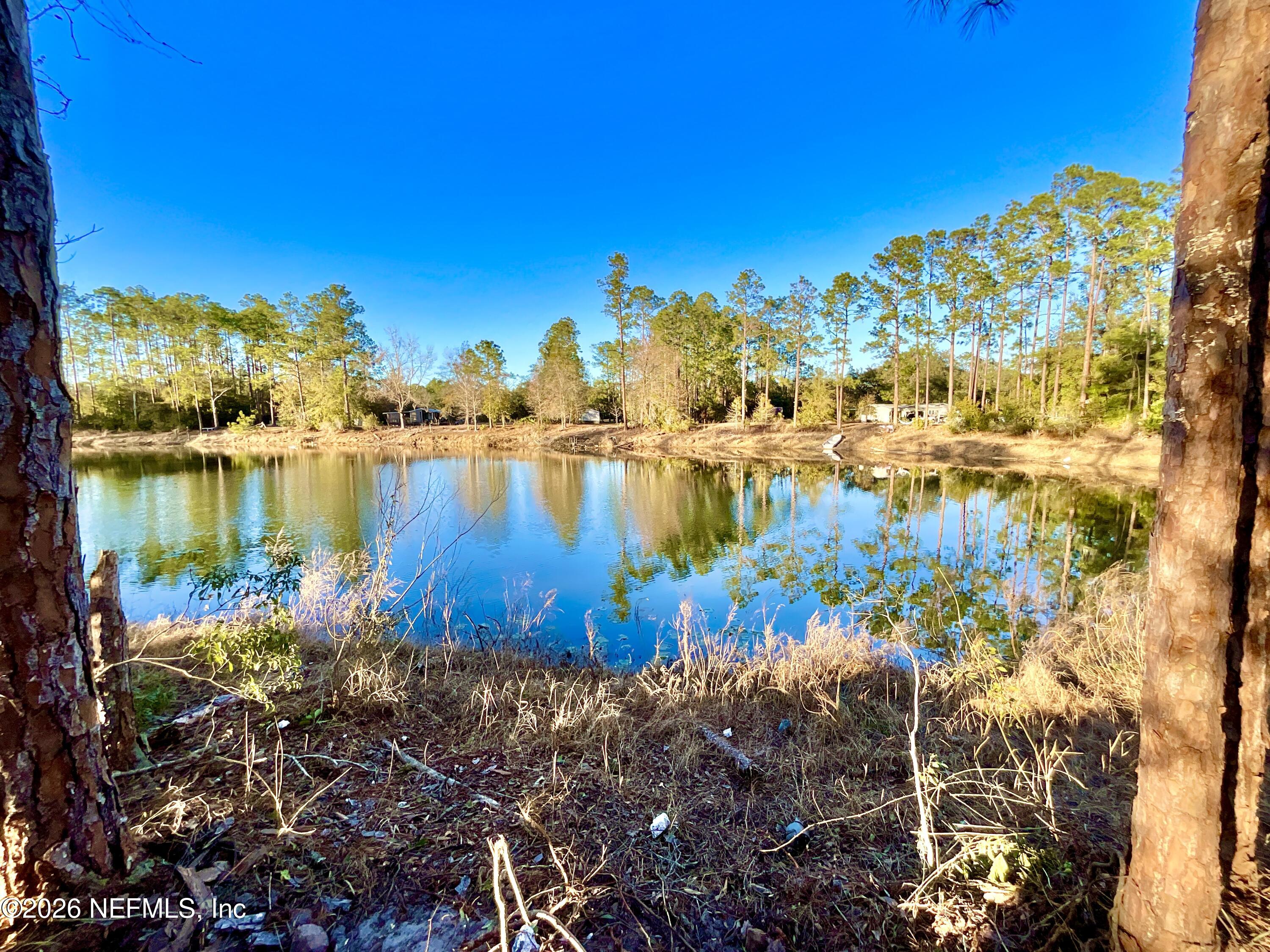 104 Howard Drive Interlachen, FL 32148 - Photo 3 of 6 a view of a lake with a house in the background