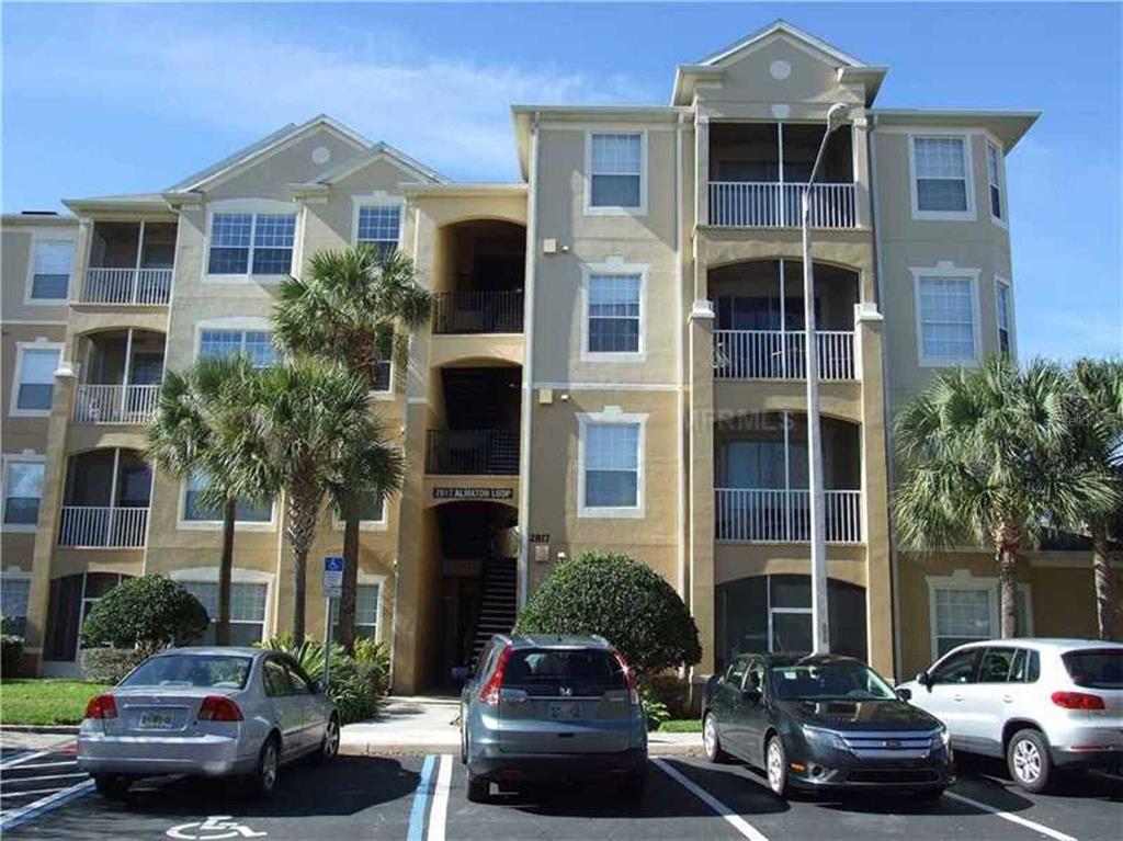 a view of a car parked in front of a brick building