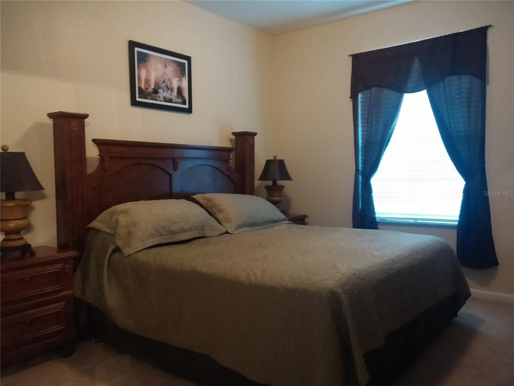 2817 Almaton Loop, Unit 304 Kissimmee, FL 34747 - Photo 11 of 26 a bedroom with a bed and a window