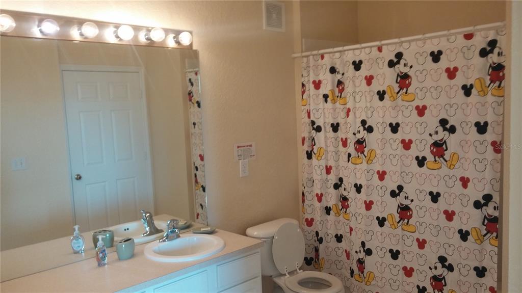 2817 Almaton Loop, Unit 304 Kissimmee, FL 34747 - Photo 14 of 26 a bathroom with a sink toilet and shower