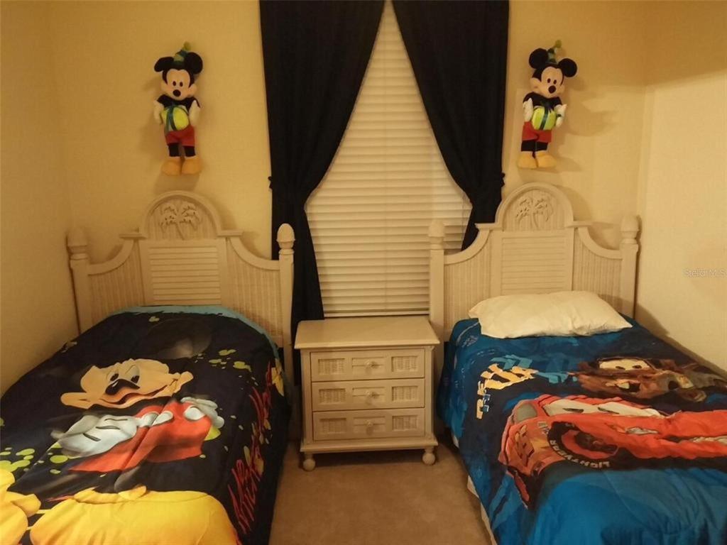 2817 Almaton Loop, Unit 304 Kissimmee, FL 34747 - Photo 16 of 26 a bedroom with a bed and a window